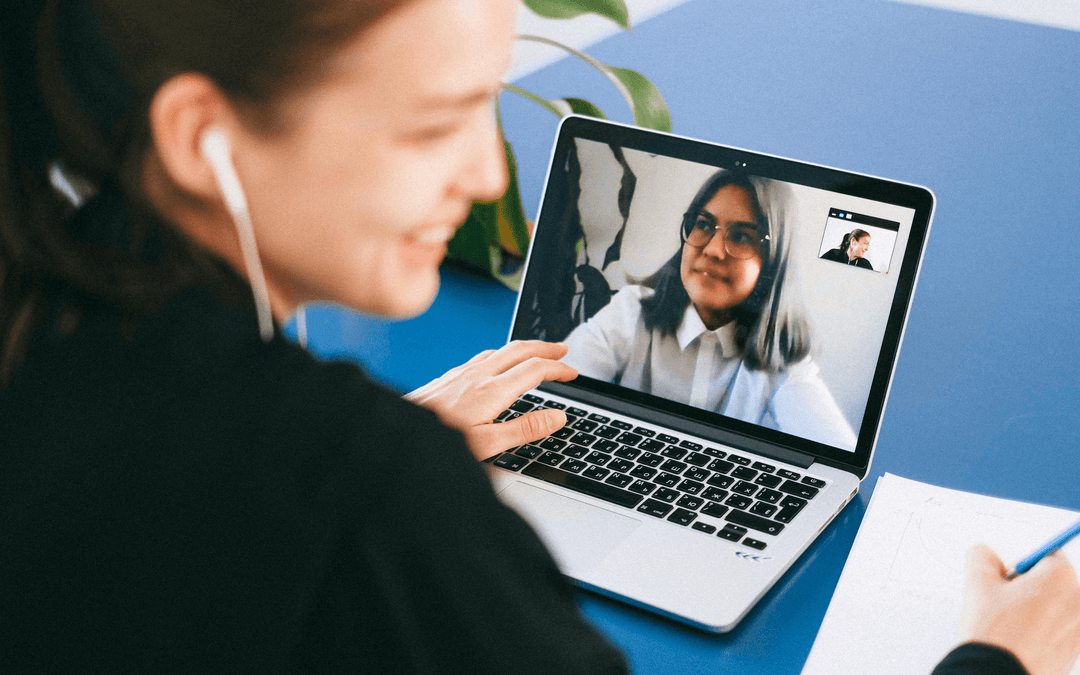 Two professionals engaging in a video call using a laptop, demonstrating effective virtual communication.